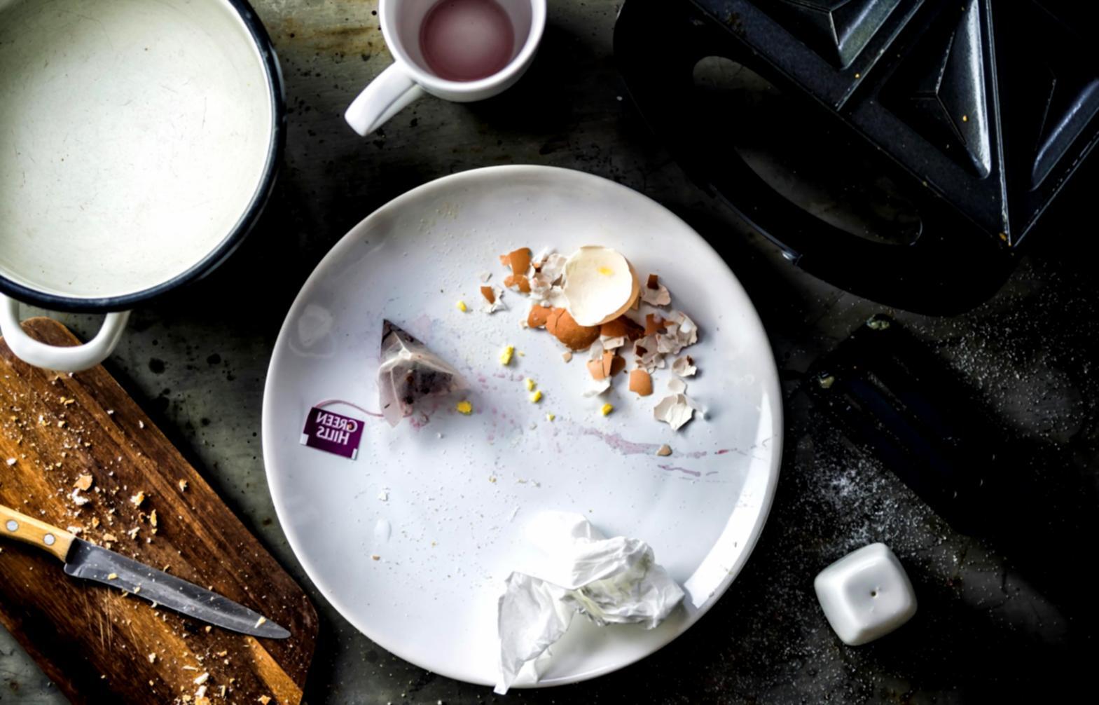 Students practicing cooking techniques in a modern kitchen environment